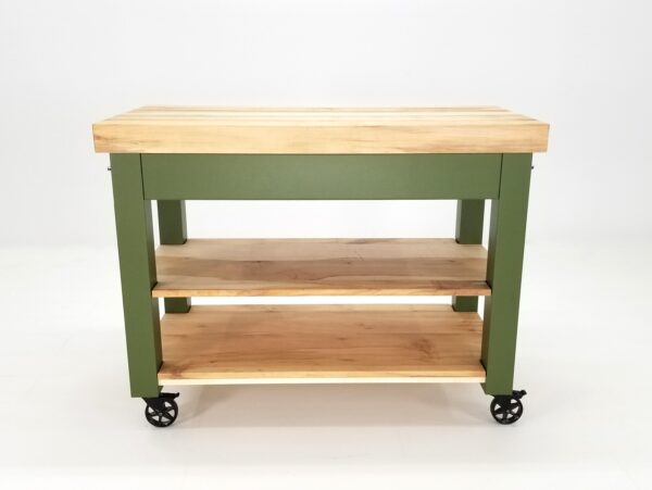 A back-end view of a green butcher block kitchen island with shelves underneath it.