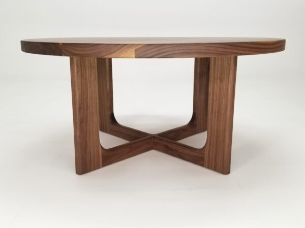 A CARY Round Cross Leg Coffee Table with a cross legged base.