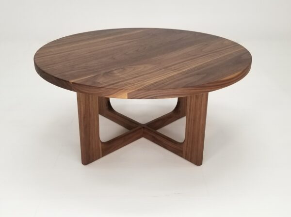 A CARY Round Cross Leg Coffee Table with a wooden base, featuring cross legs.
