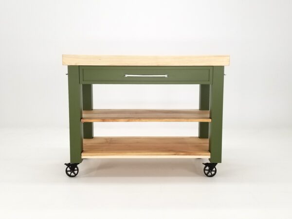 A green butcher block kitchen island with shelves underneath it.