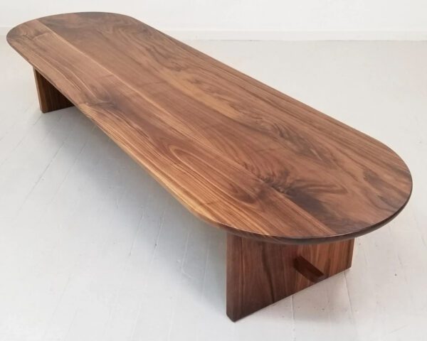 A walnut trestle coffee table.