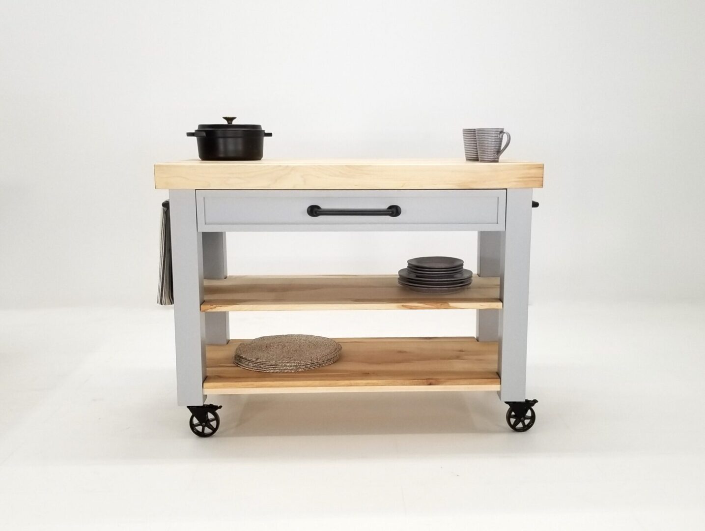A CHEF Custom Maple Butcher Block Cart on wheels with a pot on top.