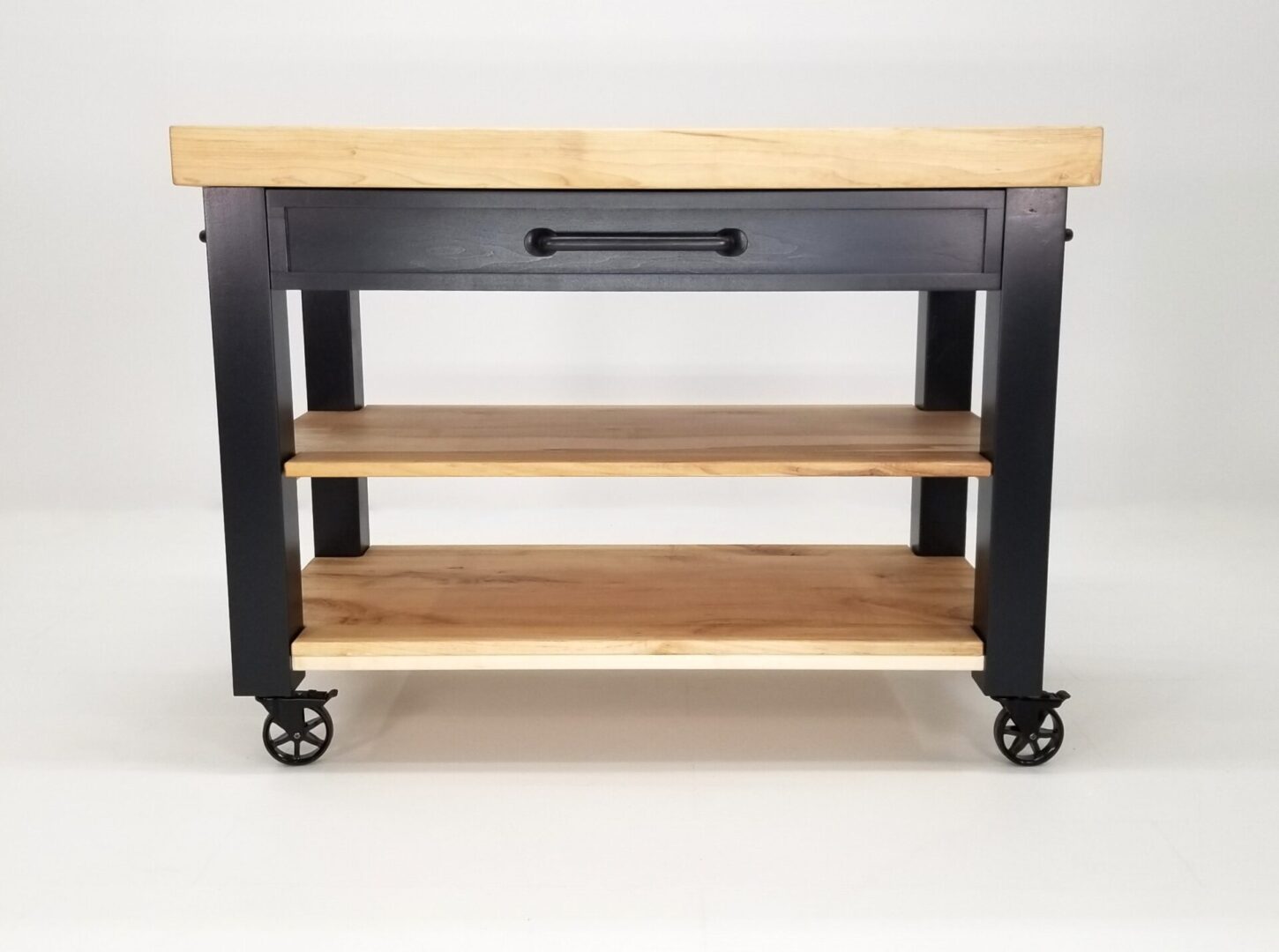 A wooden-top CHEF Custom Maple Butcher Block Cart on wheels, also known as a butcher block cart.