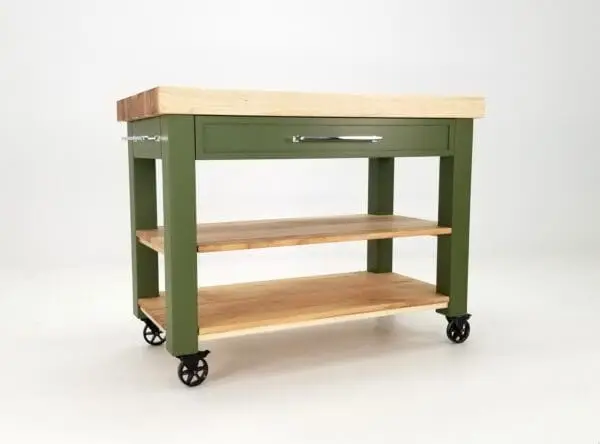 A green butcher block kitchen island with shelves underneath it.