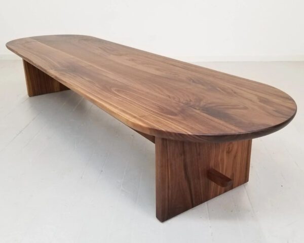 A walnut trestle coffee table.