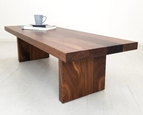 A wooden panel coffee table with a coffee mug on top of it.