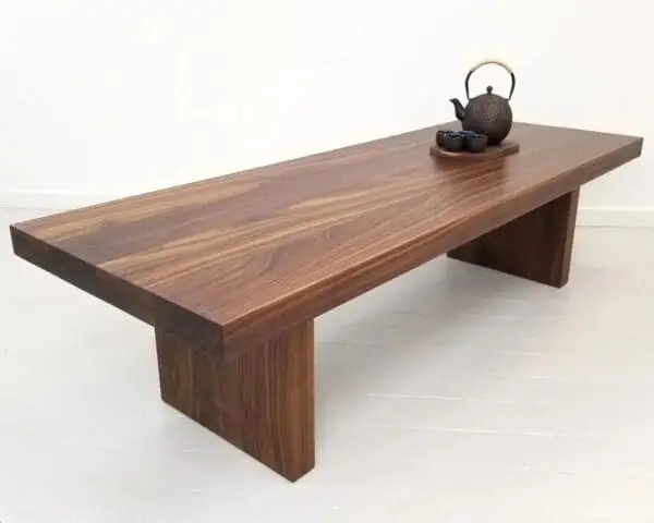 A wooden panel coffee table with decorations on top of it.