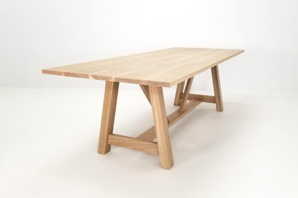 An angled shot of our a-line trestle base dining table.