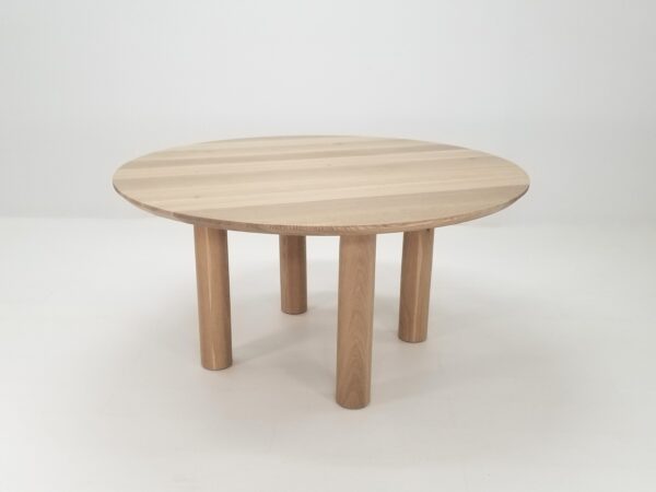 A natural white oak round dining table.