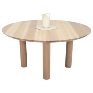 A round dining table with a vase on top.