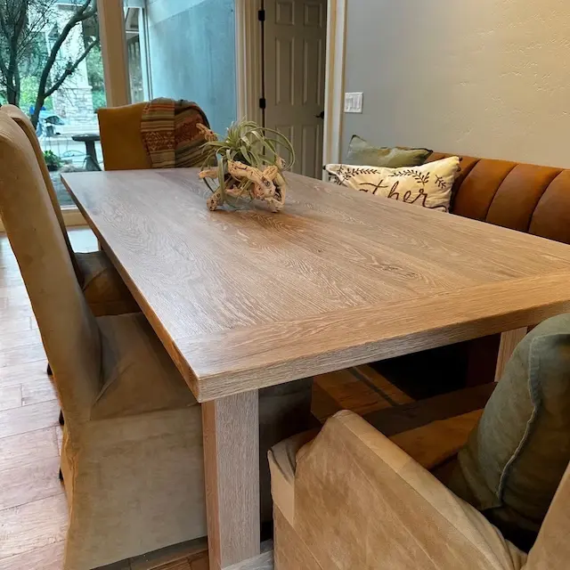 A dining room table with a bench and chairs, captured in client photos.
