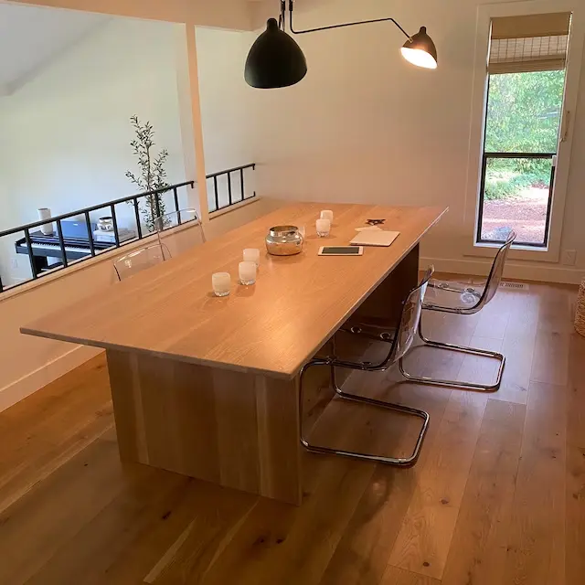 A conference table with hardwood floors ideal for client photos.