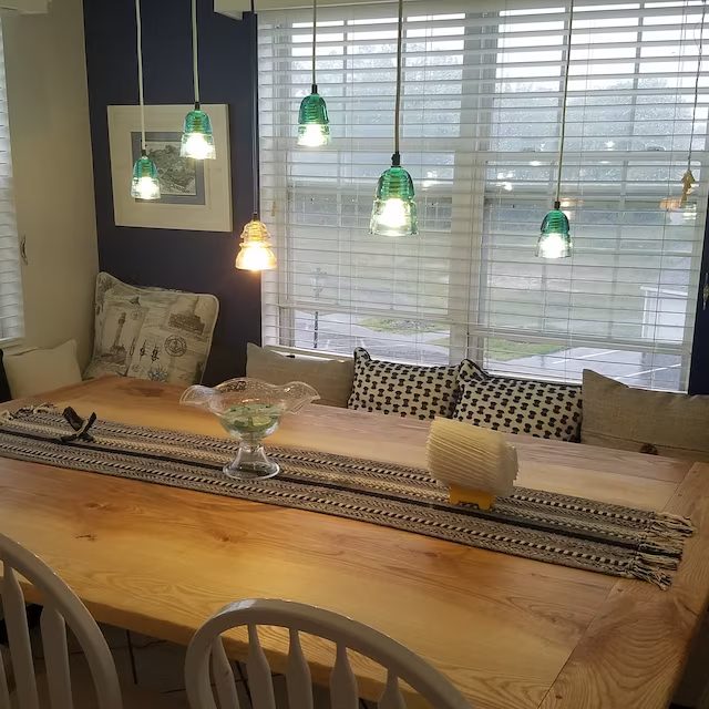 Client photos of a dining room with a wooden table and chairs.