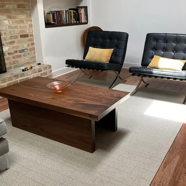 A living room with client photos displayed on a coffee table and chairs.
