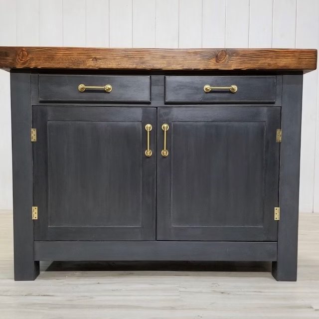 A kitchen island with two drawers and brass handles, perfect for showcasing in client photos.