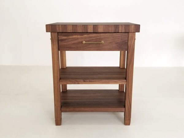 The front view of a walnut end-grain butcher block kitchen island.