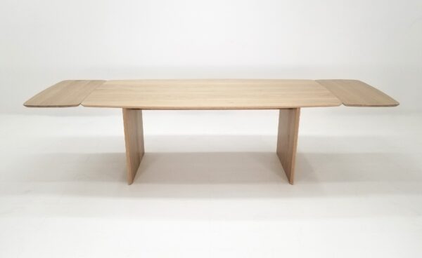 A white oak table with a beveled edge and 18" table extensions.