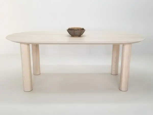 Our COVE dining table in sunwashed ash, with a bowl on top of it.