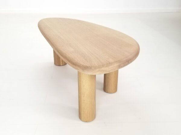 A freeform coffee table in natural white oak.