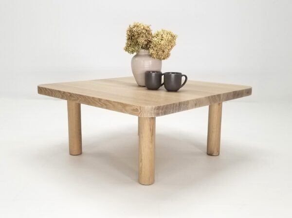 A seawashed, quarter-sawn white oak coffee table with vases and mugs.