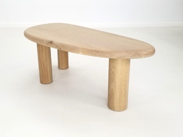 A freeform coffee table in natural white oak.