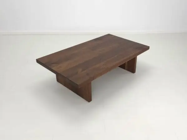 A dark wooden coffee table with a minimalist design.