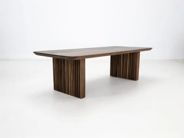 A walnut coffee table with ribbed legs.