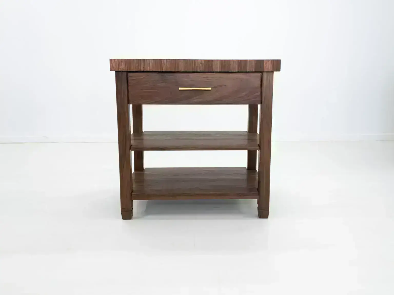 A walnut butcher block kitchen island with an end grain top