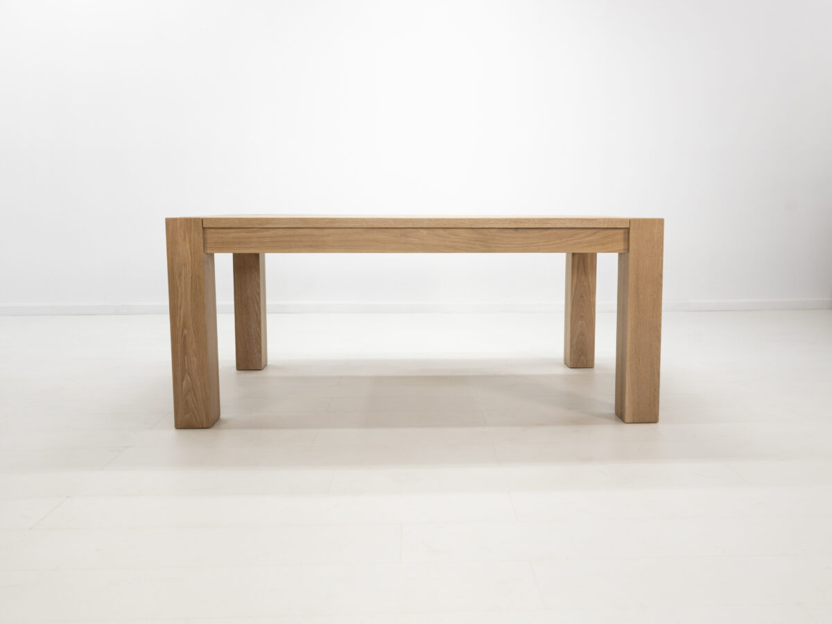 JAQI dining table in seawashed white oak finish featuring a seamless top with breadboard ends