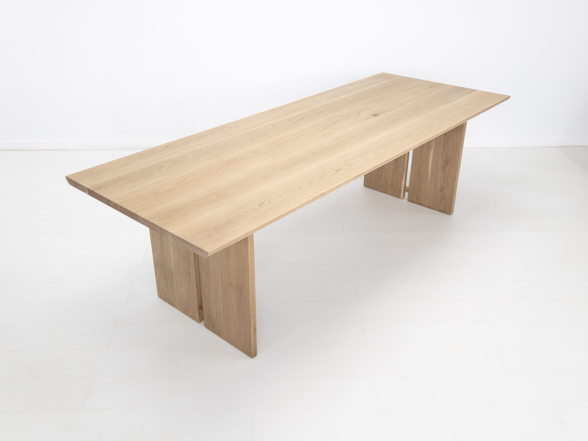 Top view of the 15 inch thick solid wood tabletop with beveled edge on the DIVI dining table