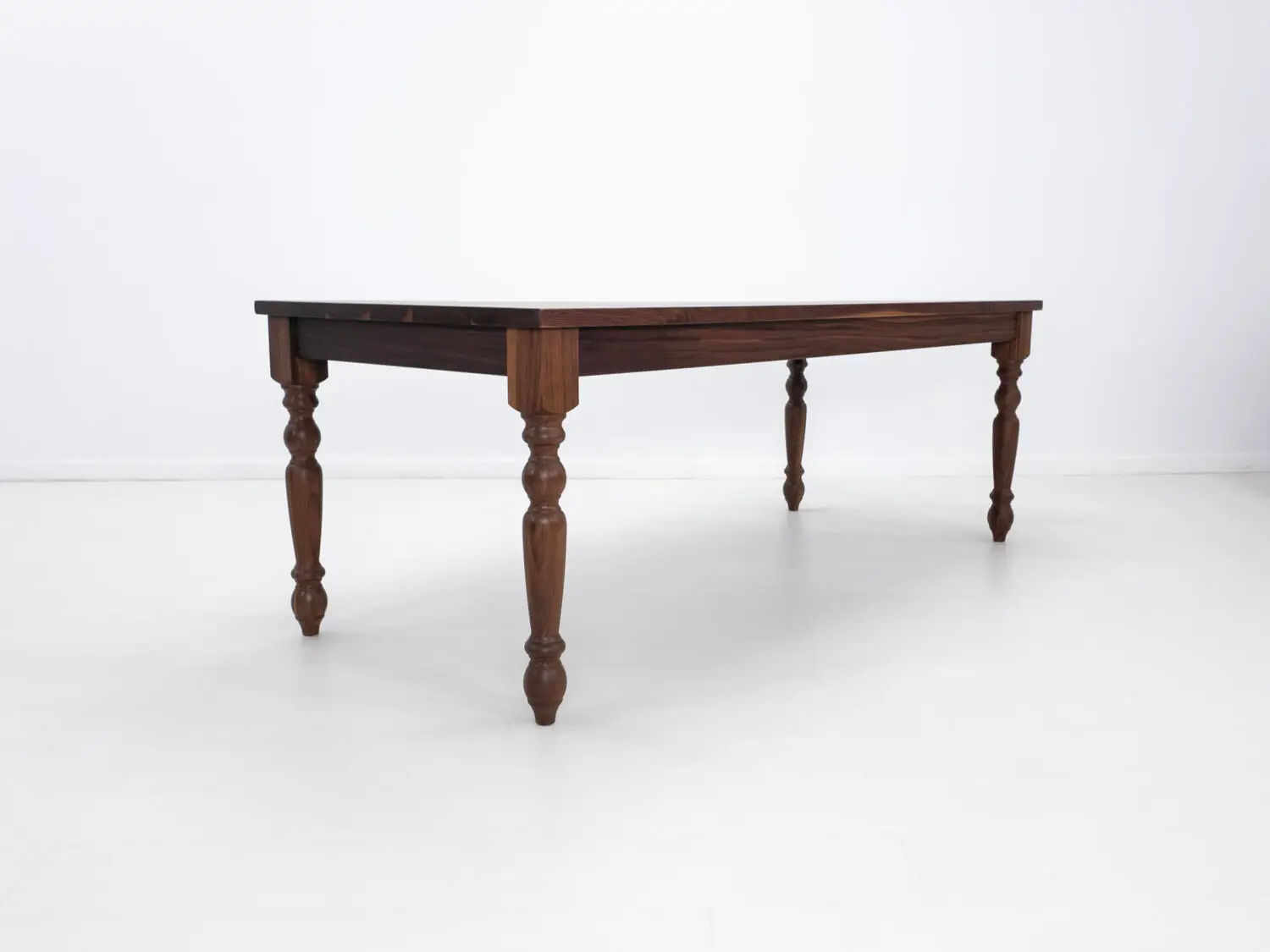 Traditional farmhouse style TESS table with turned legs designed to be a timeless centerpiece in any dining space