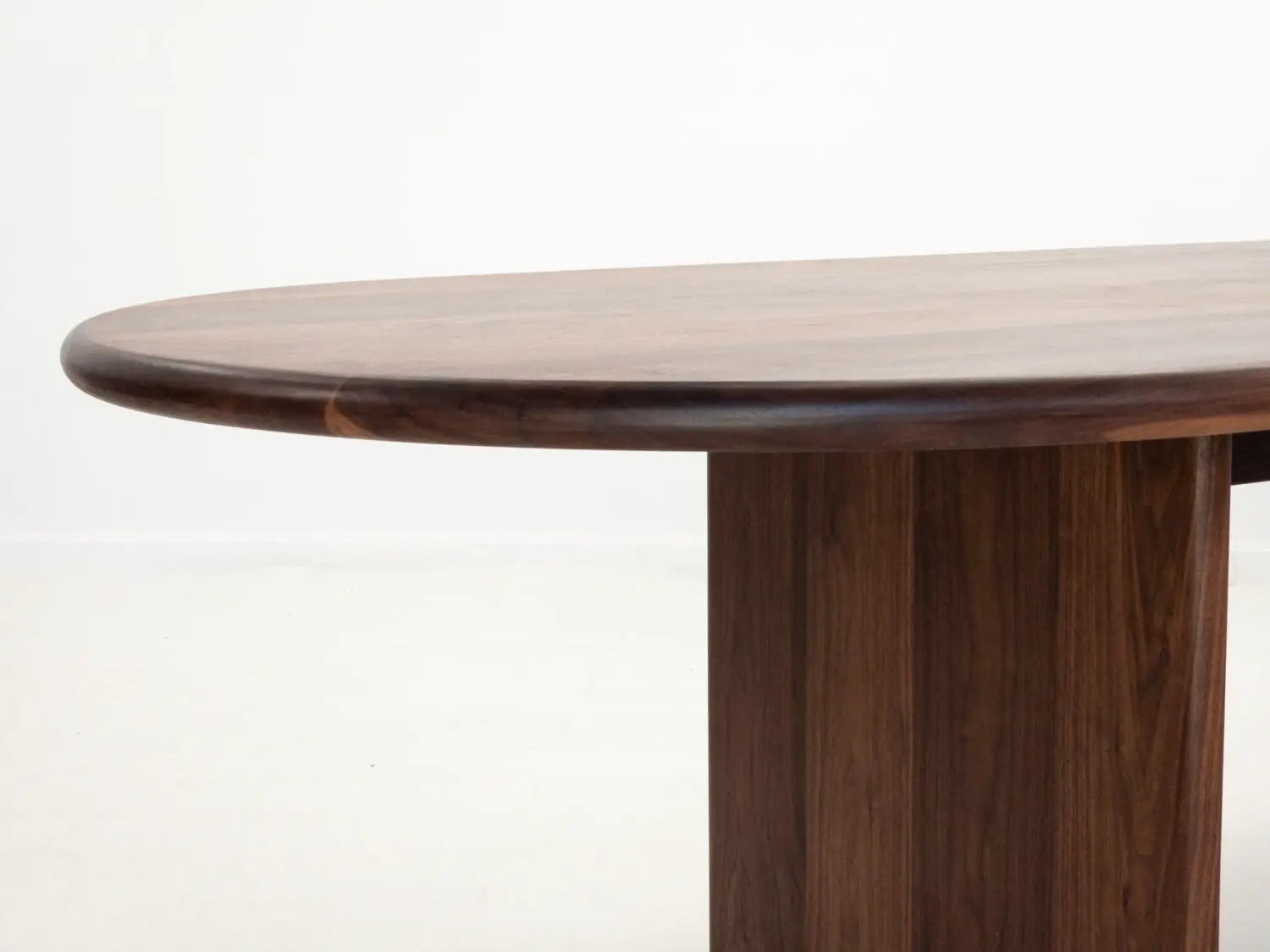 Close up of the solid walnut tabletop  Displaying the rich grain and smooth hand finished surface
