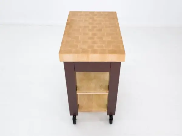 Wooden kitchen island with shelves and wheels.