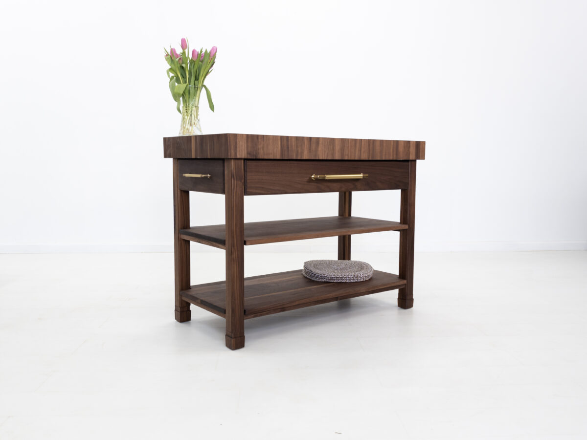 Handcrafted kitchen island featuring a 4 inch thick end grain walnut butcher block top