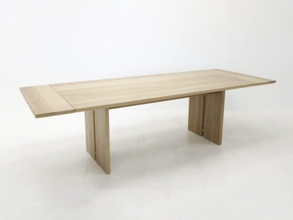 A panel table with split legs and extensions.