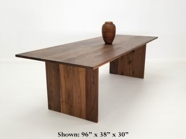 A walnut dining table with a vase on top of it.
