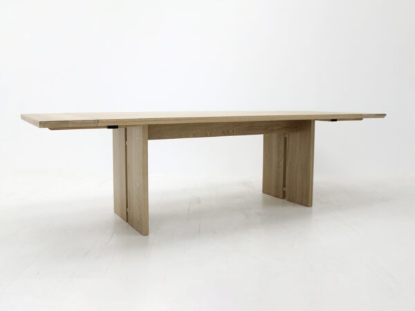 A panel table with split legs and extensions.