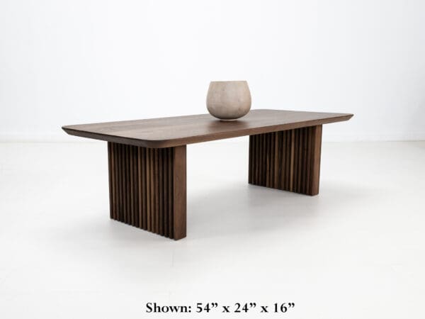 A walnut coffee table with ribbed legs and the sizing shown below.