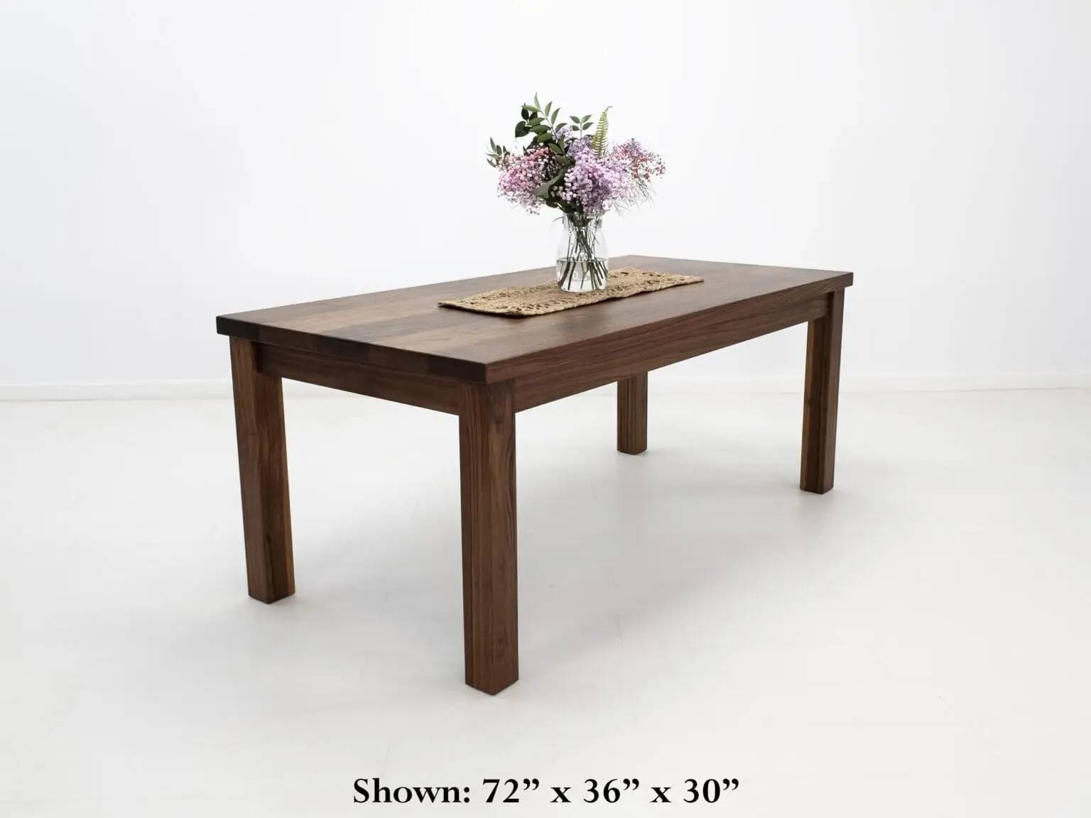 A walnut dining table with decor on top of it