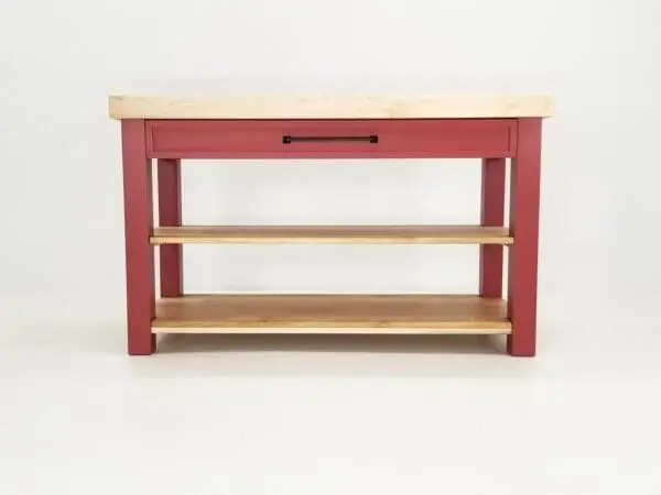 Red kitchen island with shelves and drawer.