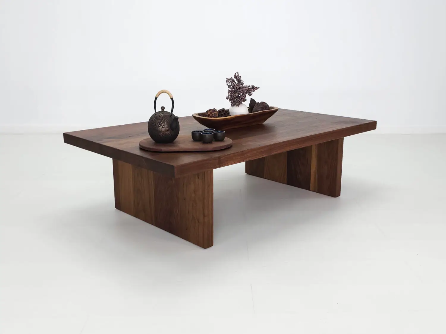 LILY coffee table in solid walnut with a 2 inch thick slab style top and panel legs