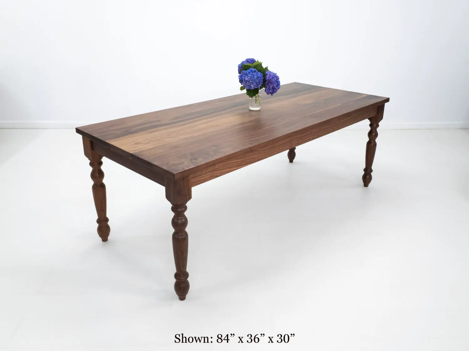 Traditional farmhouse style TESS table with turned legs designed to be a timeless centerpiece in any dining space