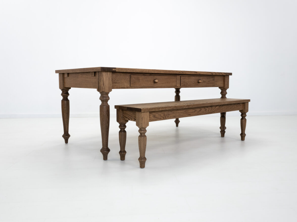 Front view of the ETTA dining table in Antique Harvest showcasing its turned legs and Shaker styled drawers