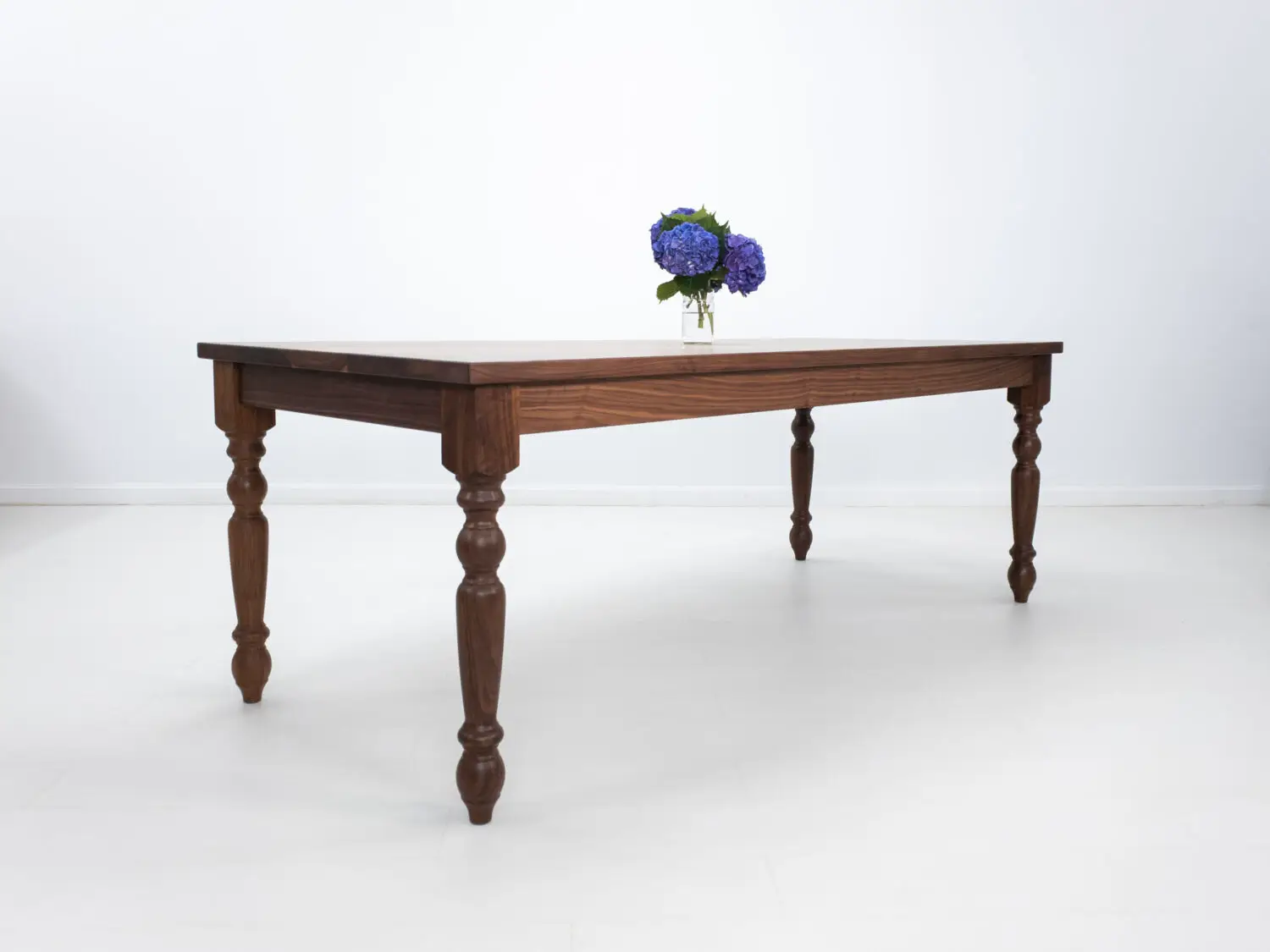 Traditional farmhouse style TESS table with turned legs designed to be a timeless centerpiece in any dining space