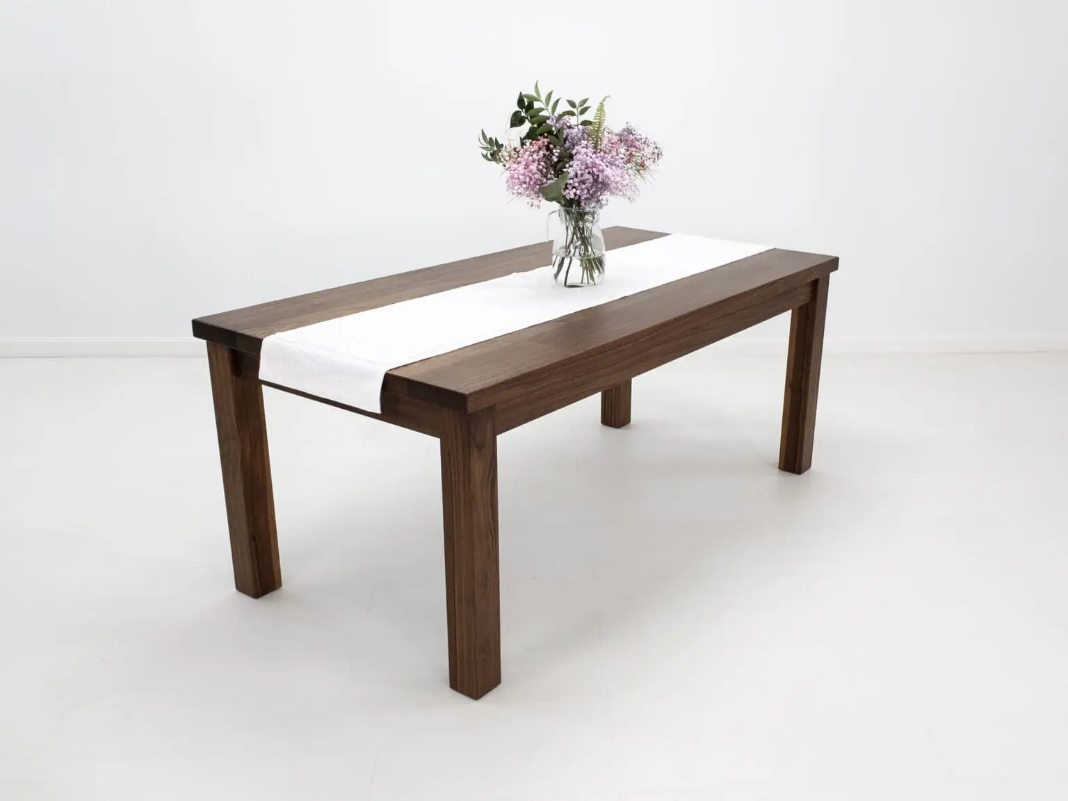 A walnut dining table with decor on top of it