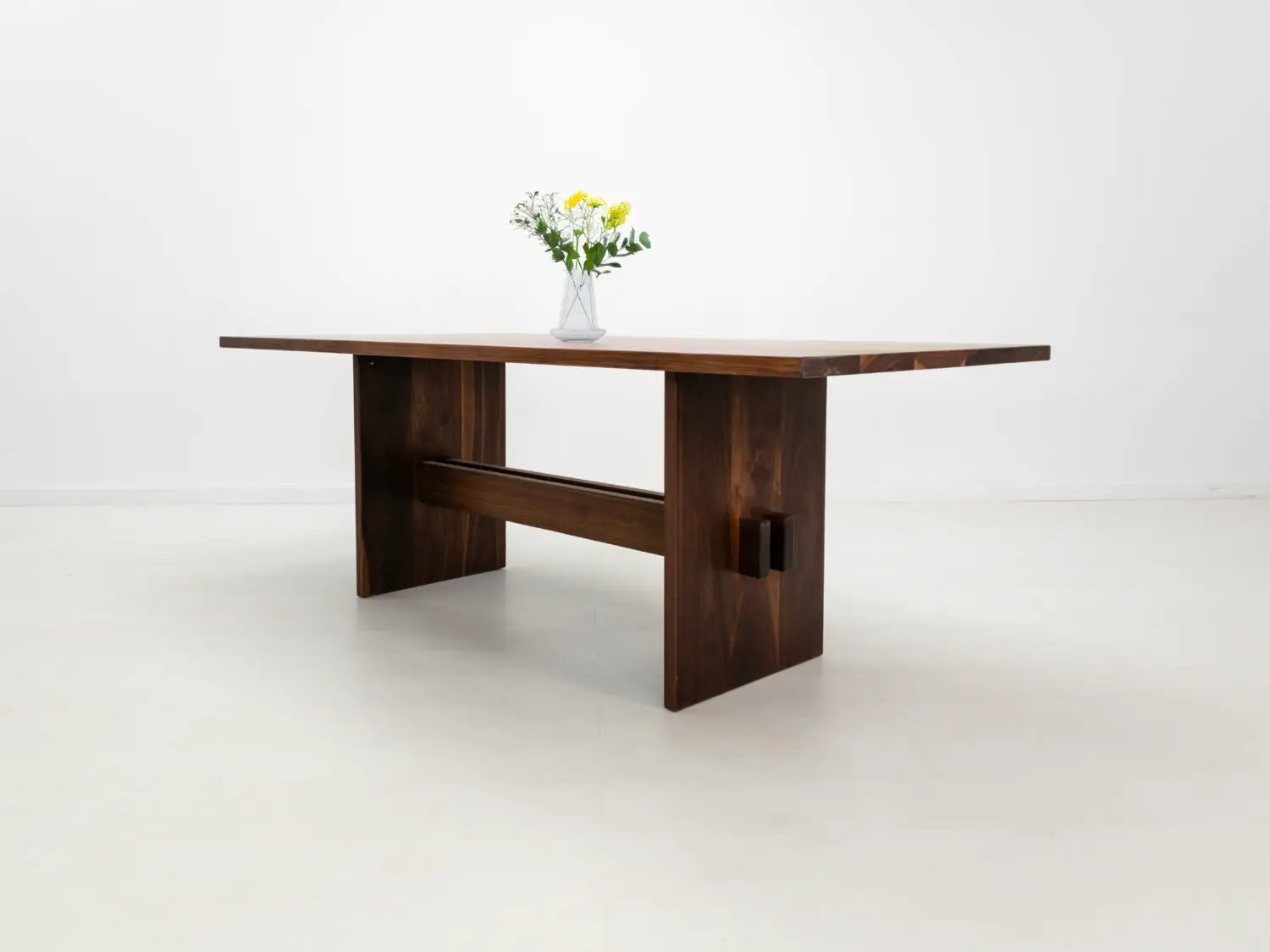 Side view of DUKE dining table showing double stretcher base and slab legs