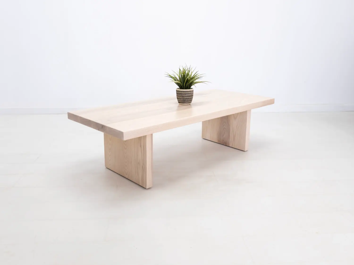 LILY coffee table in solid sunwashed ash with a 2 inch thick slab style top and panel legs