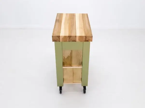 Green kitchen island with wood top.