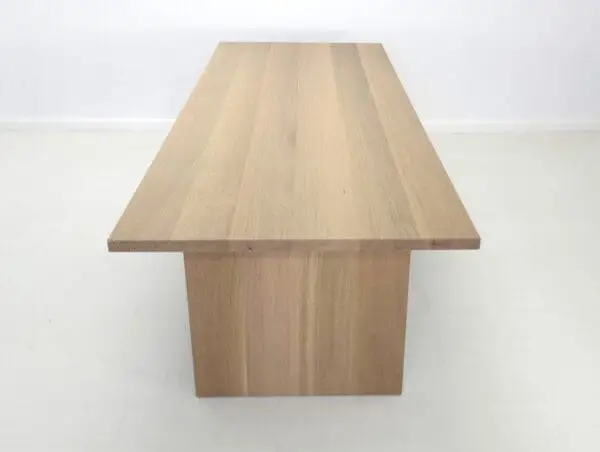 A close up of a white oak panel dining table.