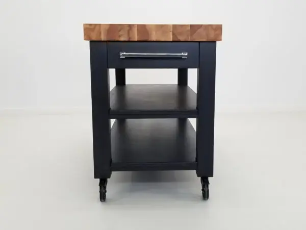 A side view of a black butcher block cart.